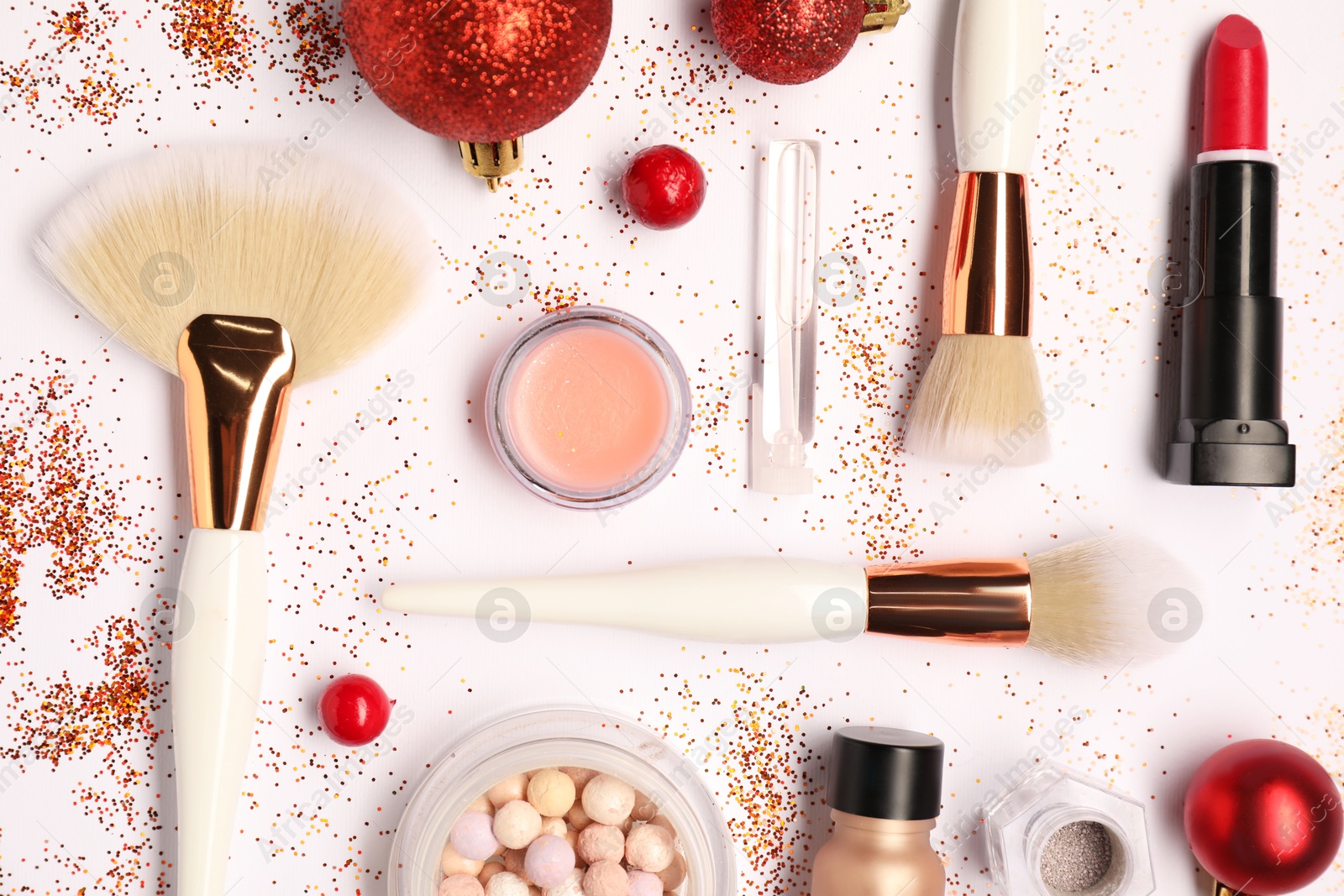 Photo of Different makeup brushes, decorative cosmetics and Christmas decor on white background, flat lay