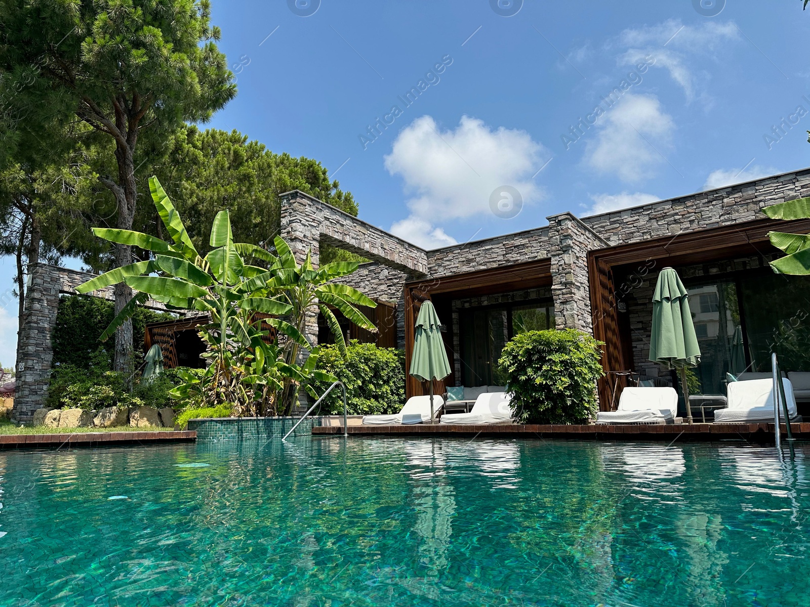 Photo of Outdoor swimming pool with clear water at luxury resort