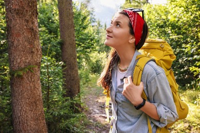 Photo of Young hiker with backpack enjoying time in forest