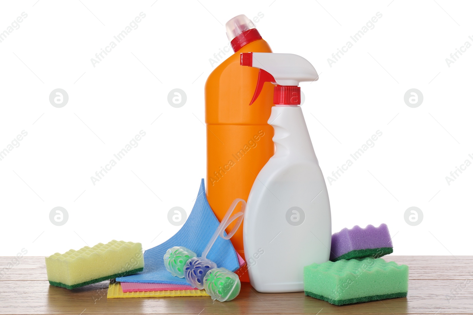 Photo of Different toilet cleaners, sponges and napkins on wooden table against white background