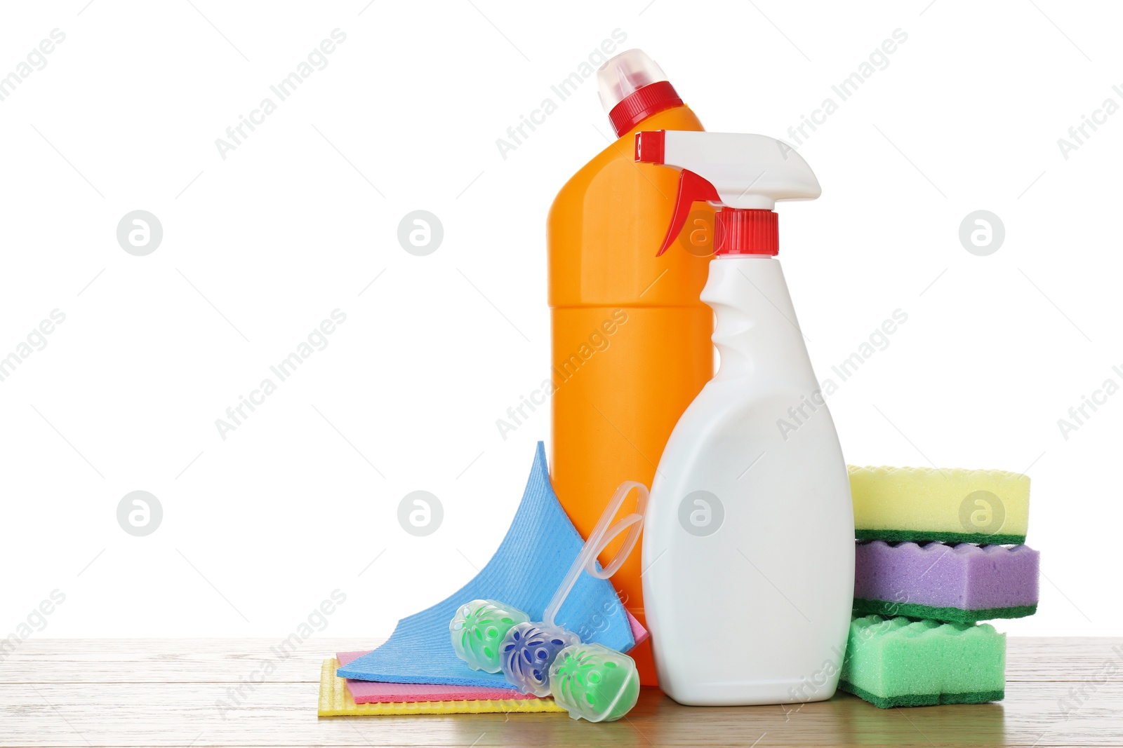 Photo of Different toilet cleaners, sponges and napkins on wooden table against white background