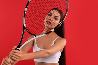 Photo of Beautiful young woman with tennis racket on red background