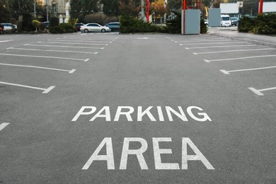 Empty outdoor parking lot with painted markings on asphalt