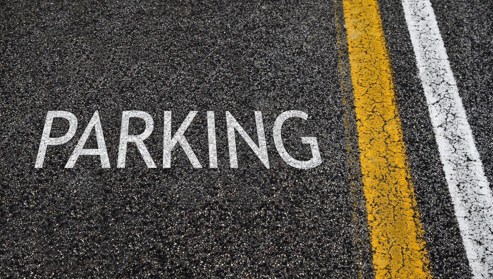 Image of Parking lot. Word Parking written on asphalt