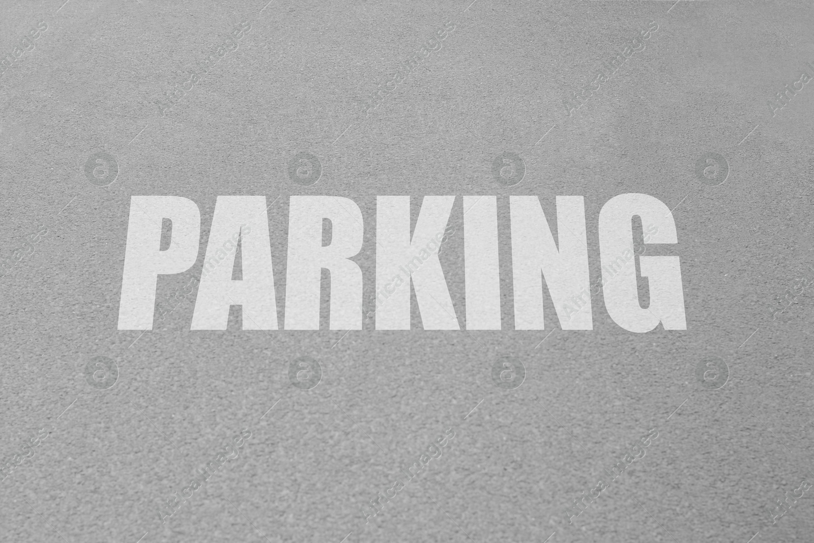 Image of Parking lot. Word Parking written on asphalt