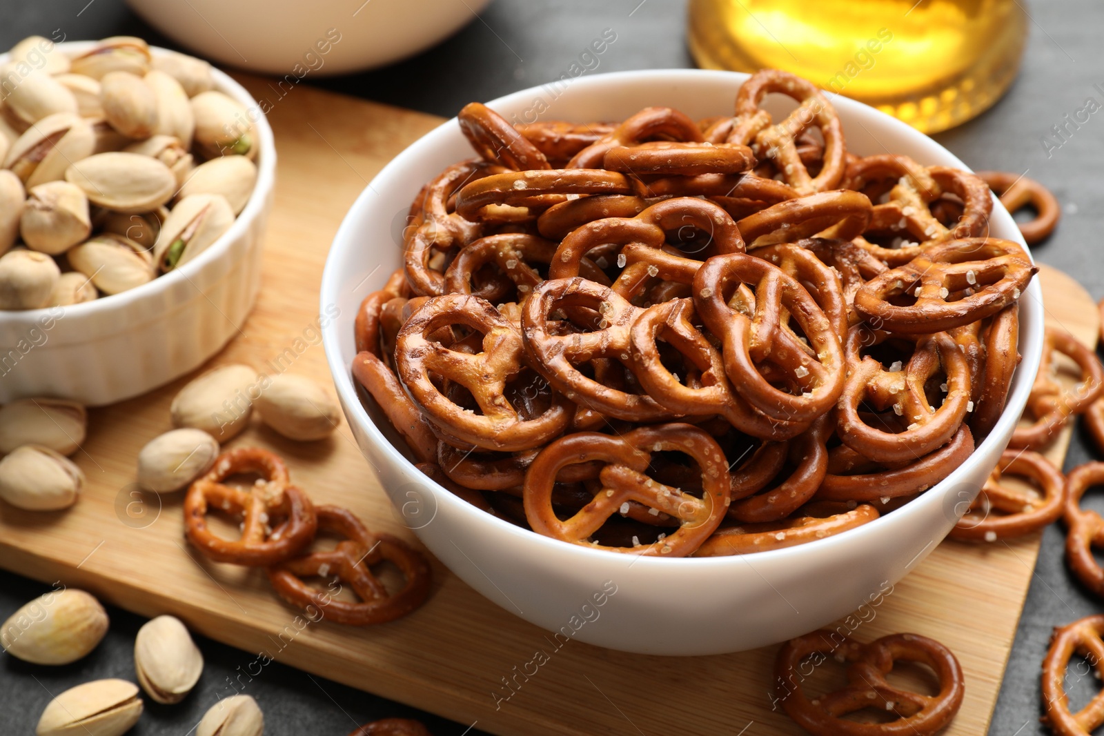 Photo of Delicious pretzel crackers on black table, closeup