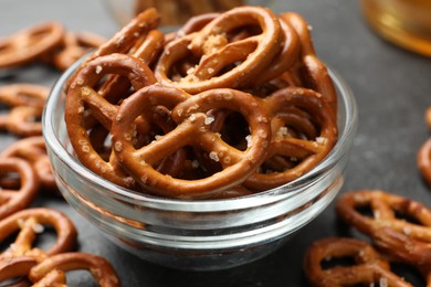 Photo of Delicious pretzel crackers on black table, closeup