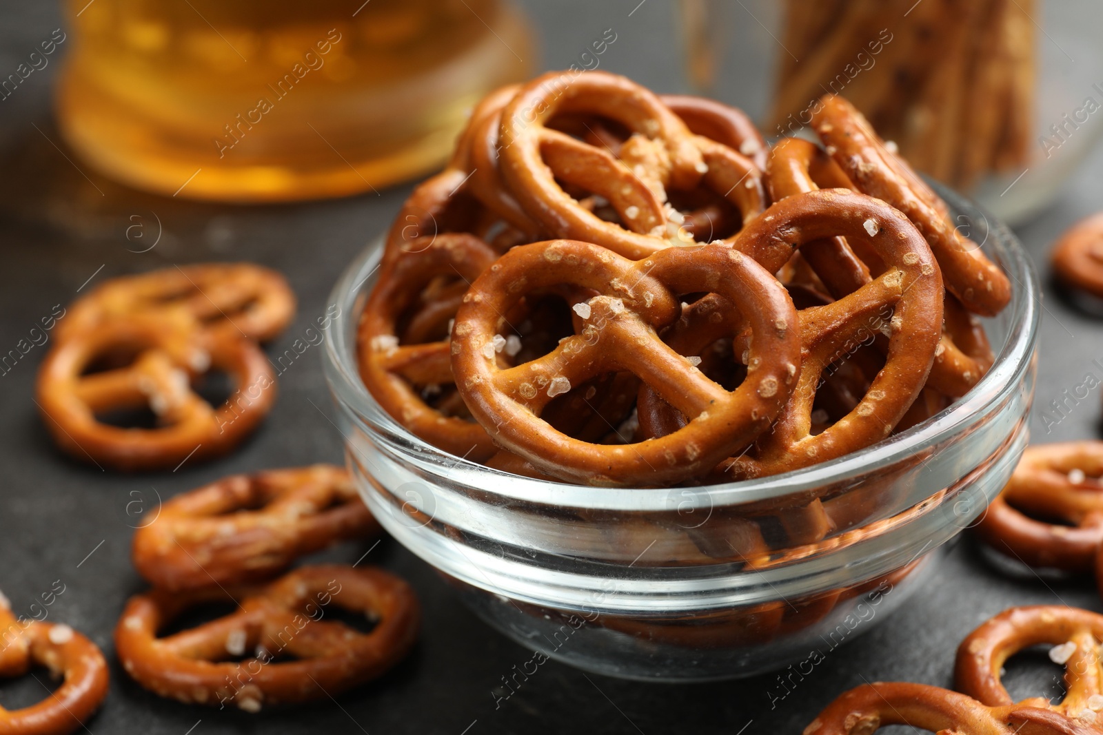 Photo of Delicious pretzel crackers on black table, closeup