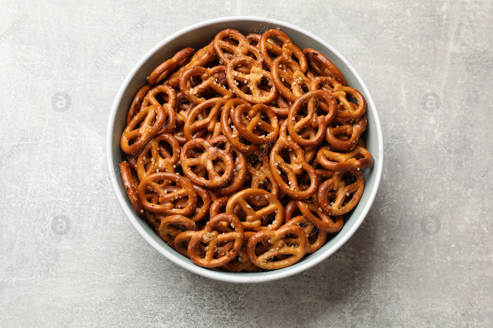 Photo of Delicious pretzel crackers on light table, top view