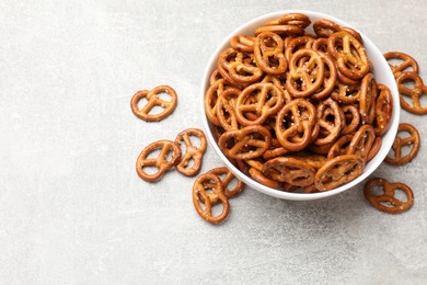 Photo of Delicious pretzel crackers on light table, top view