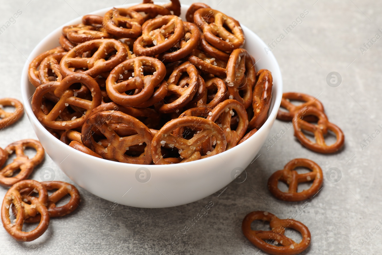 Photo of Delicious pretzel crackers on light table, closeup