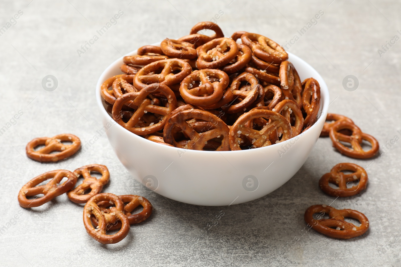 Photo of Delicious pretzel crackers on light table, closeup