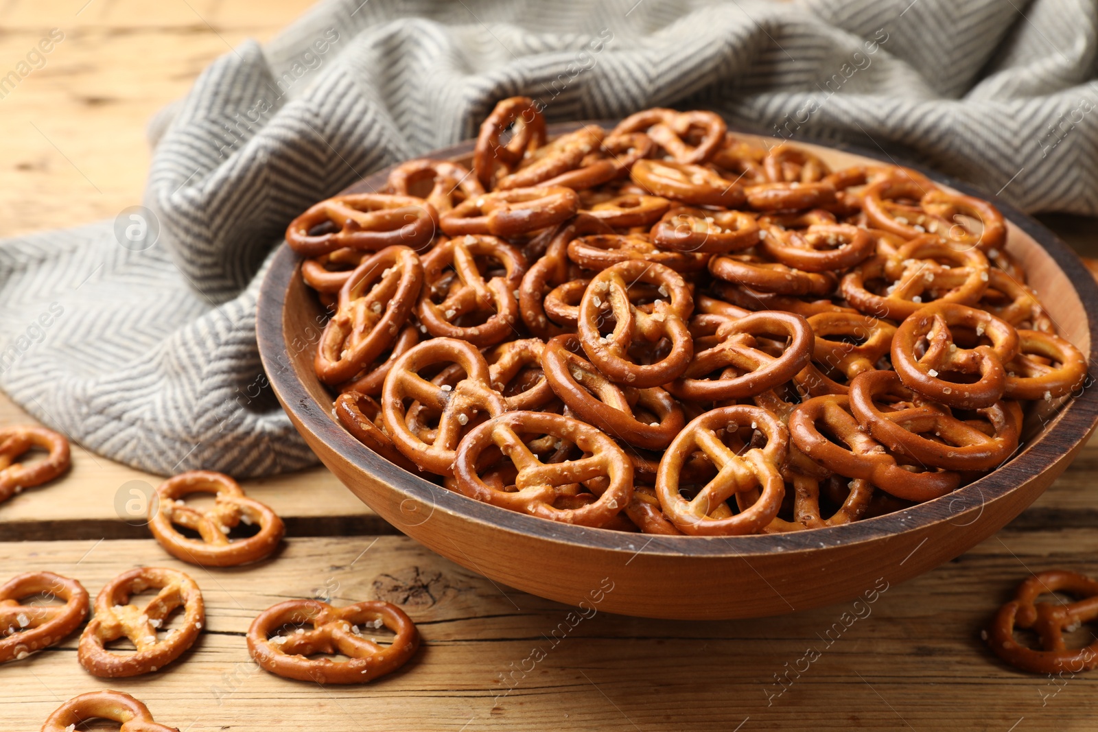 Photo of Delicious pretzel crackers on wooden table, closeup