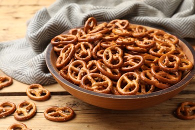 Photo of Delicious pretzel crackers on wooden table, closeup