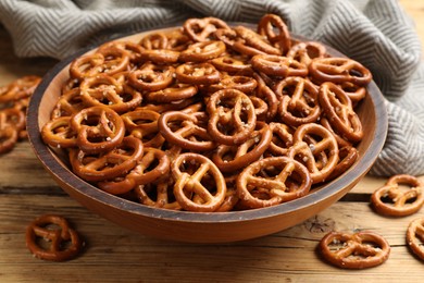 Photo of Delicious pretzel crackers on wooden table, closeup