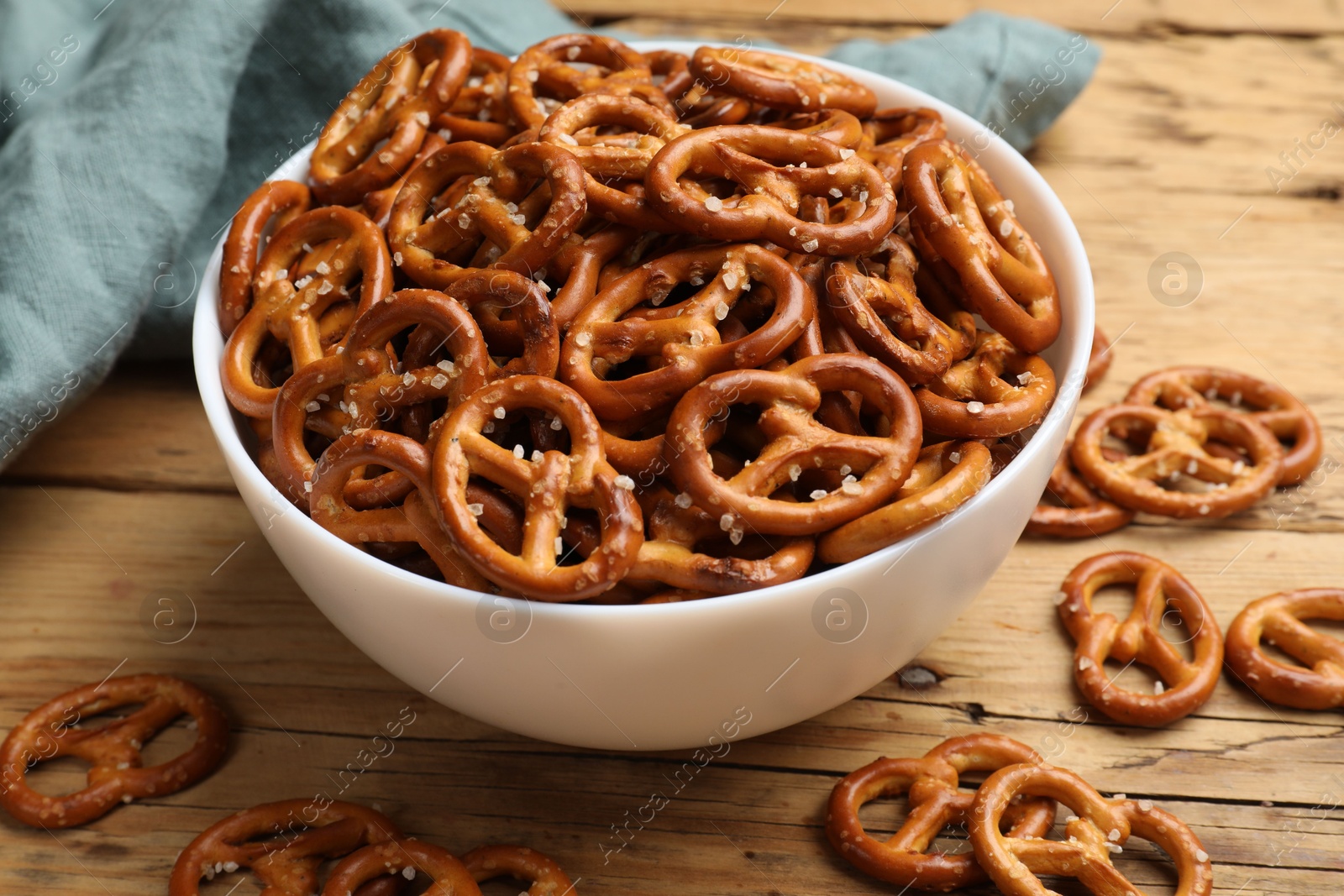 Photo of Delicious pretzel crackers on wooden table, closeup