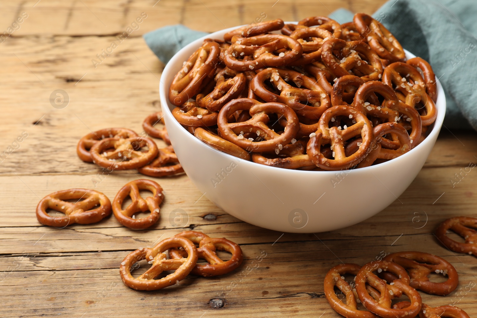 Photo of Delicious pretzel crackers on wooden table, closeup