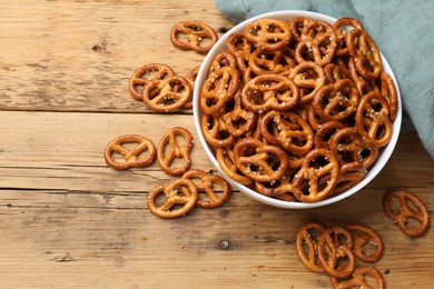 Photo of Delicious pretzel crackers on wooden table, flat lay