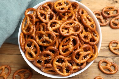 Photo of Delicious pretzel crackers on wooden table, flat lay