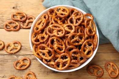 Photo of Delicious pretzel crackers on wooden table, flat lay