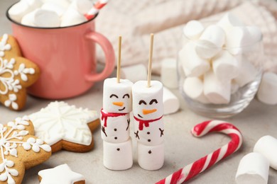 Photo of Funny snowmen made of marshmallows and other sweets on light table