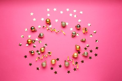 Photo of Confetti and Christmas balls on pink background, flat lay. Space for text