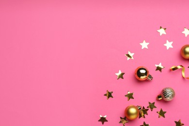 Photo of Confetti and Christmas balls on pink background, flat lay. Space for text