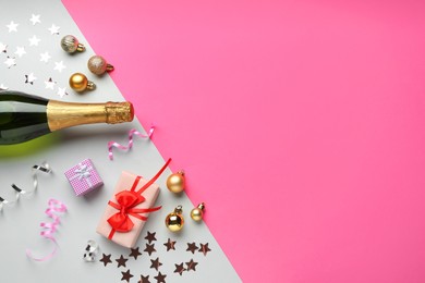 Photo of Flat lay composition with confetti and bottle of sparkling wine on color background, space for text. Christmas decor