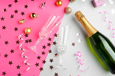 Photo of Flat lay composition with confetti and bottle of sparkling wine on color background. Christmas decor