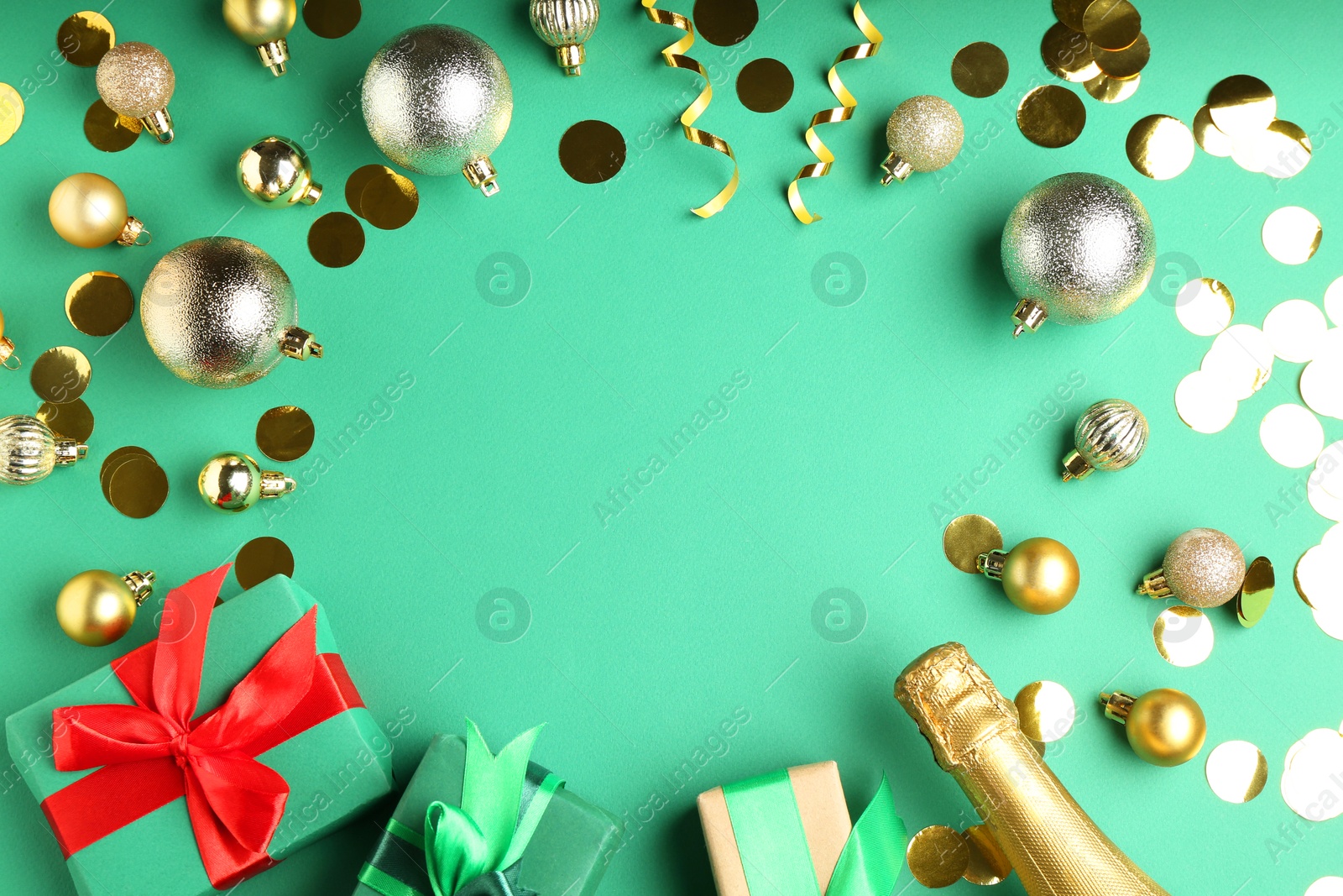 Photo of Flat lay composition with confetti and bottle of sparkling wine on green background, space for text. Christmas decor