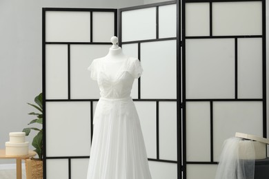 Photo of Beautiful wedding dress on mannequin in boutique