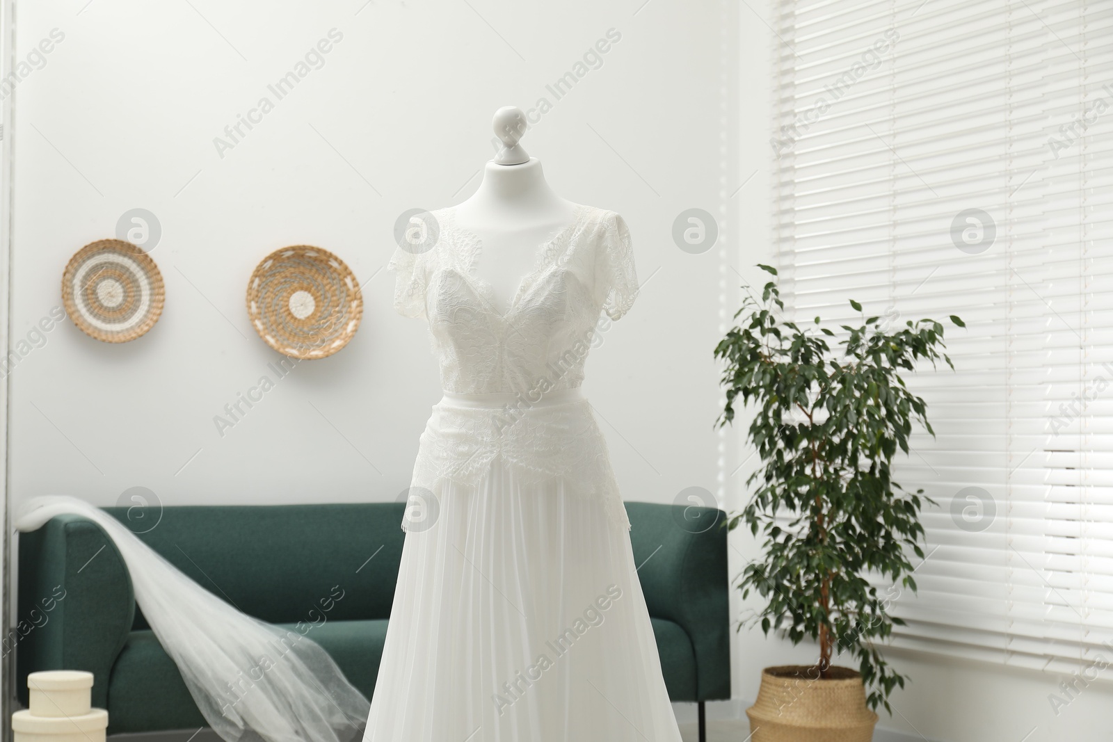 Photo of Beautiful wedding dress on mannequin in boutique