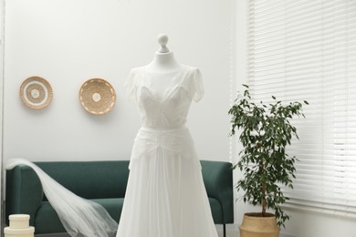 Beautiful wedding dress on mannequin in boutique