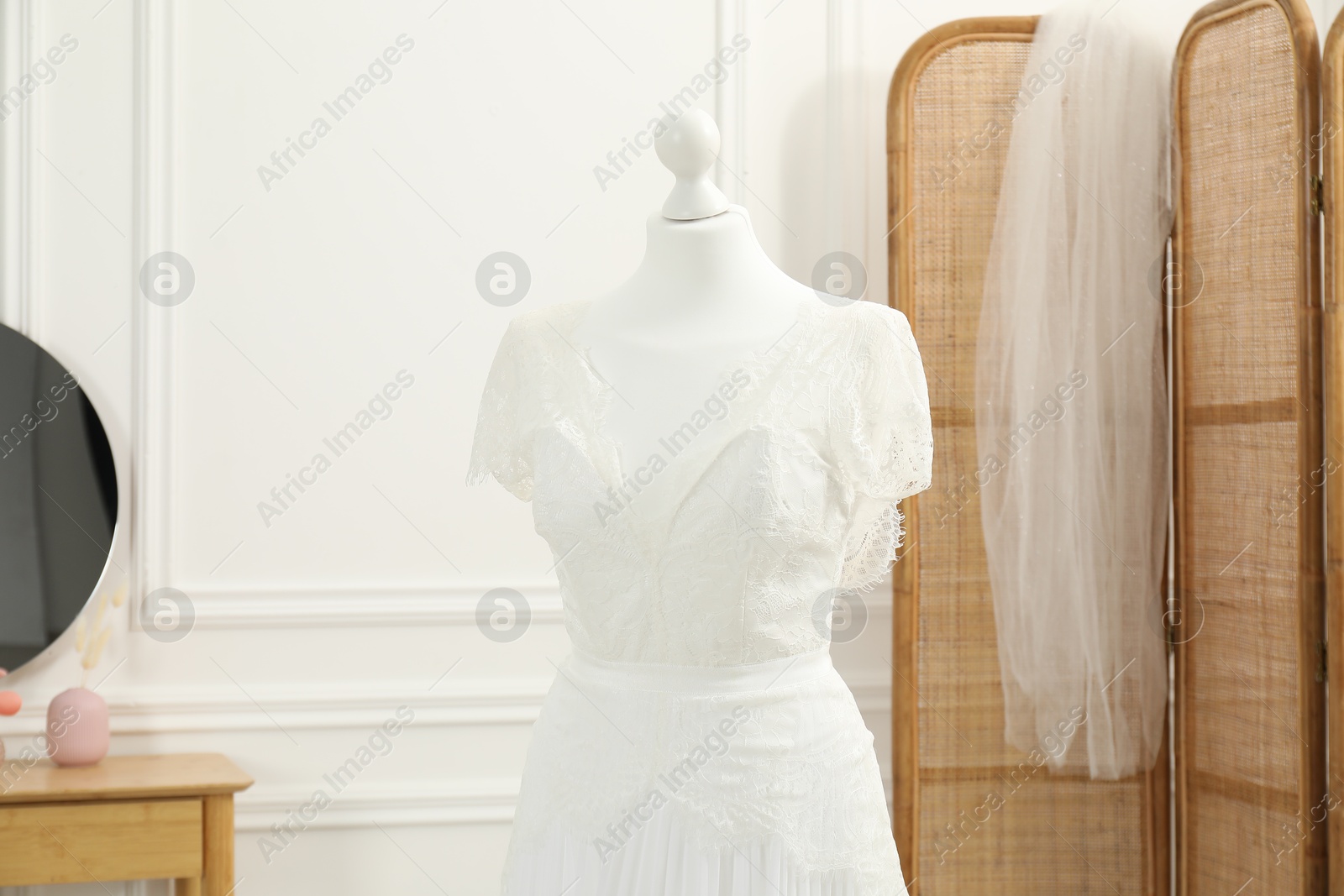 Photo of Beautiful wedding dress on mannequin in boutique