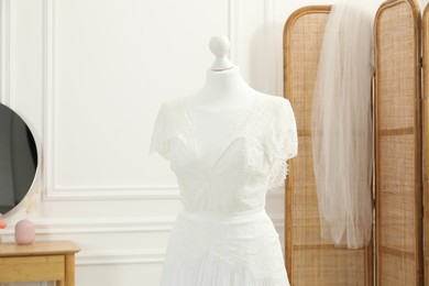 Photo of Beautiful wedding dress on mannequin in boutique