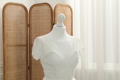 Beautiful wedding dress on mannequin in boutique