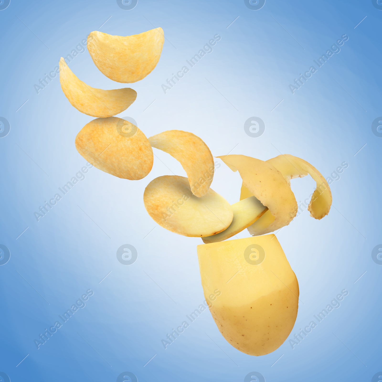 Image of Raw potato turning into tasty crispy chips in air on blue gradient background