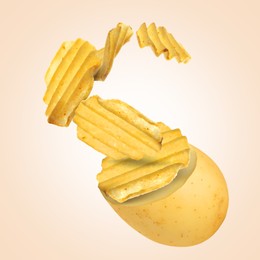 Image of Raw potato turning into tasty crispy chips in air on beige gradient background