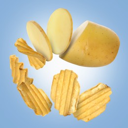 Image of Raw potato turning into tasty crispy chips in air on blue gradient background