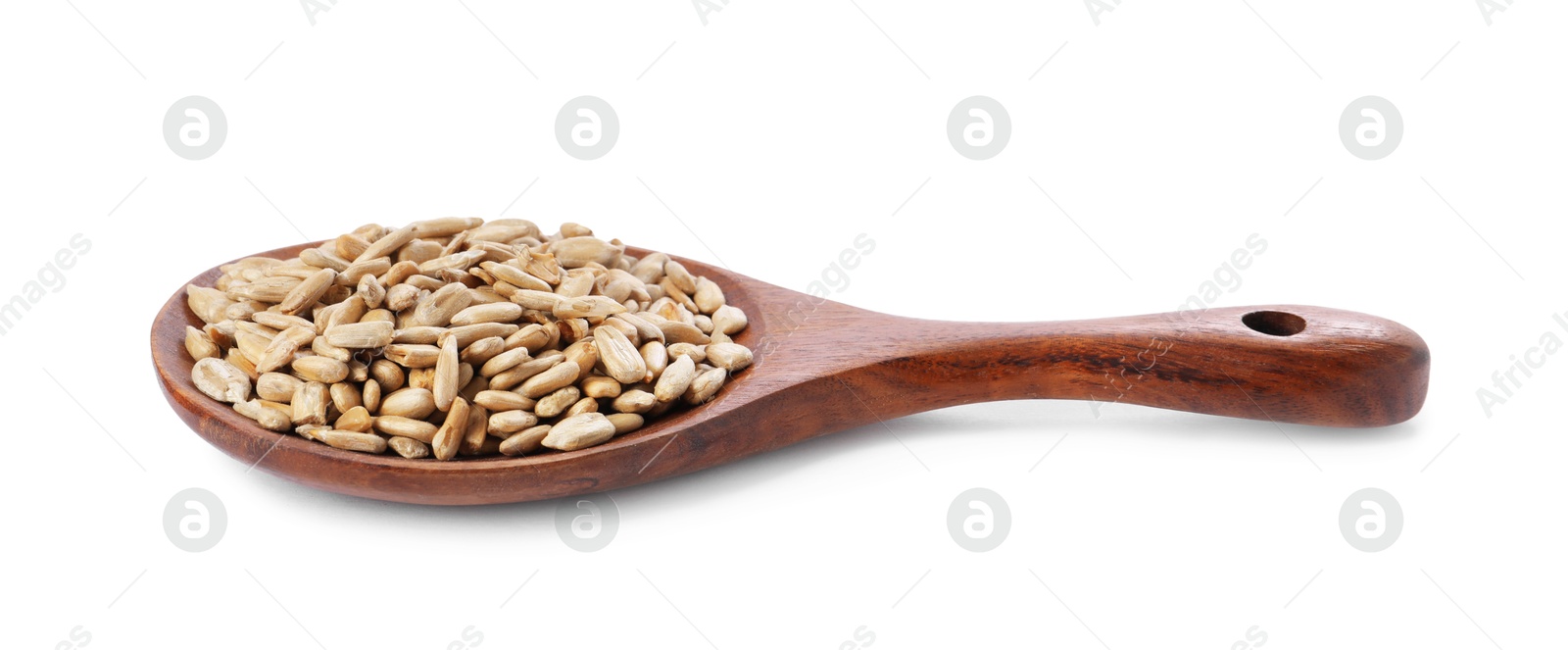 Photo of Peeled sunflower seeds in wooden spoon isolated on white