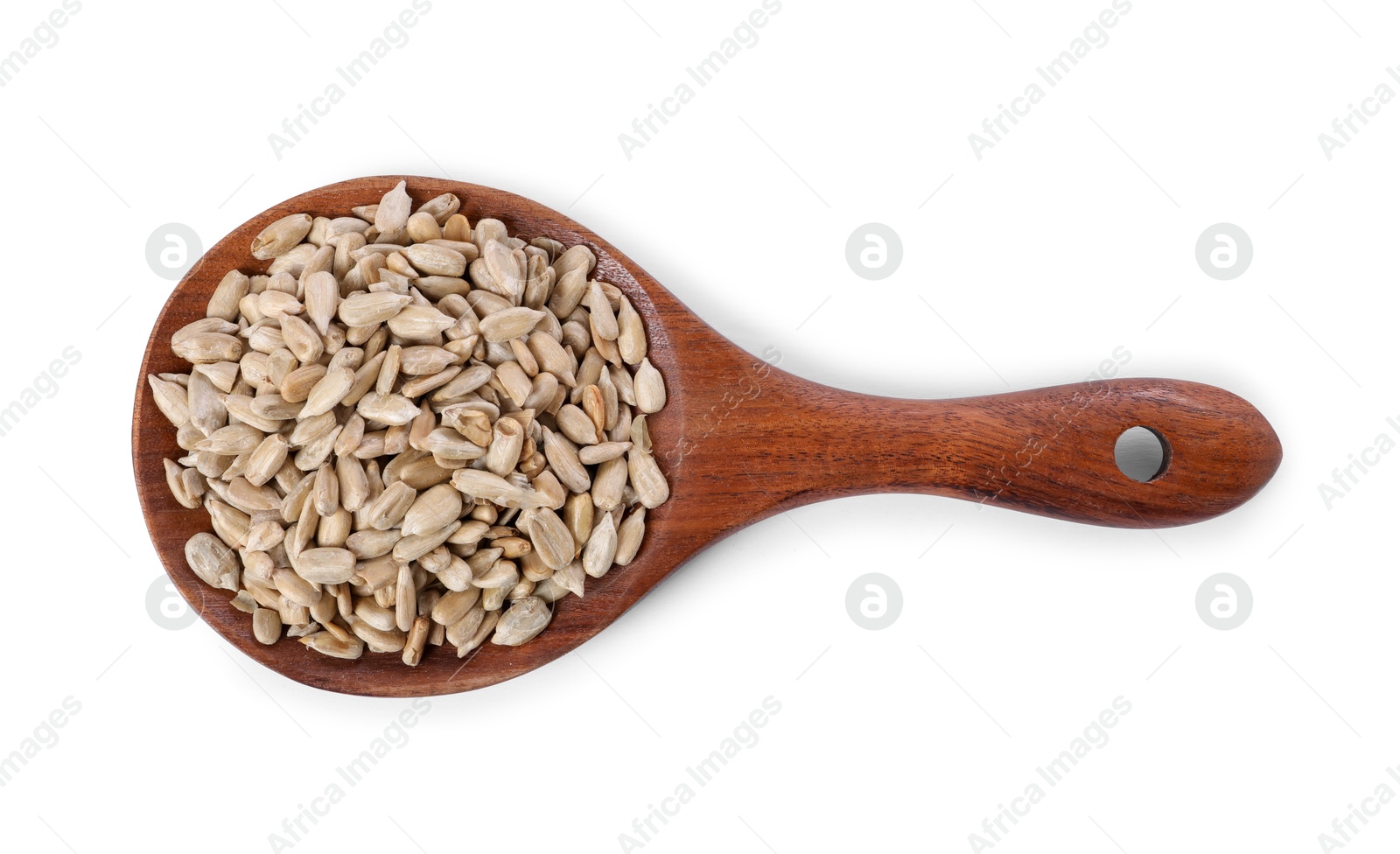 Photo of Peeled sunflower seeds in wooden spoon isolated on white, top view