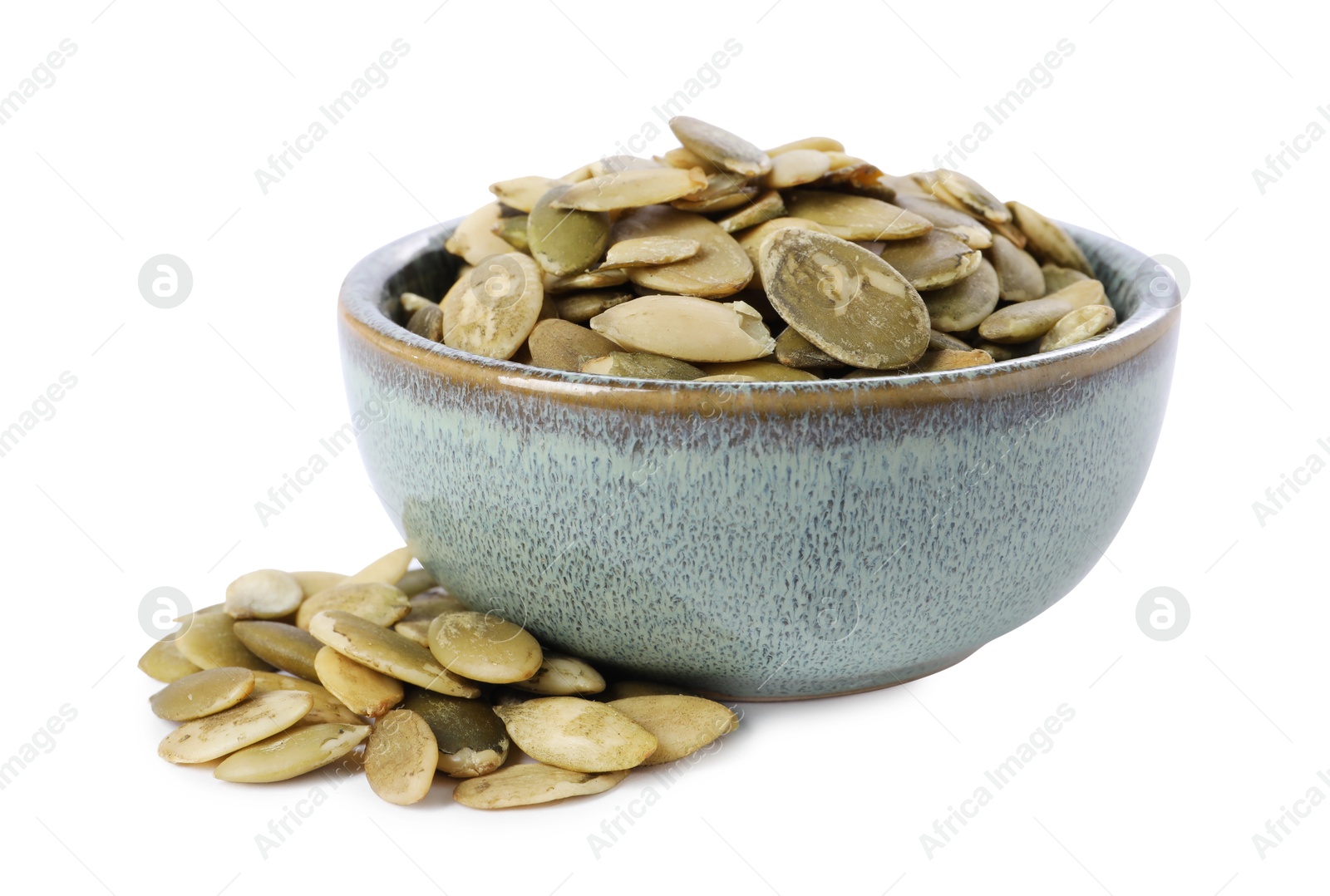 Photo of Peeled pumpkin seeds in bowl isolated on white