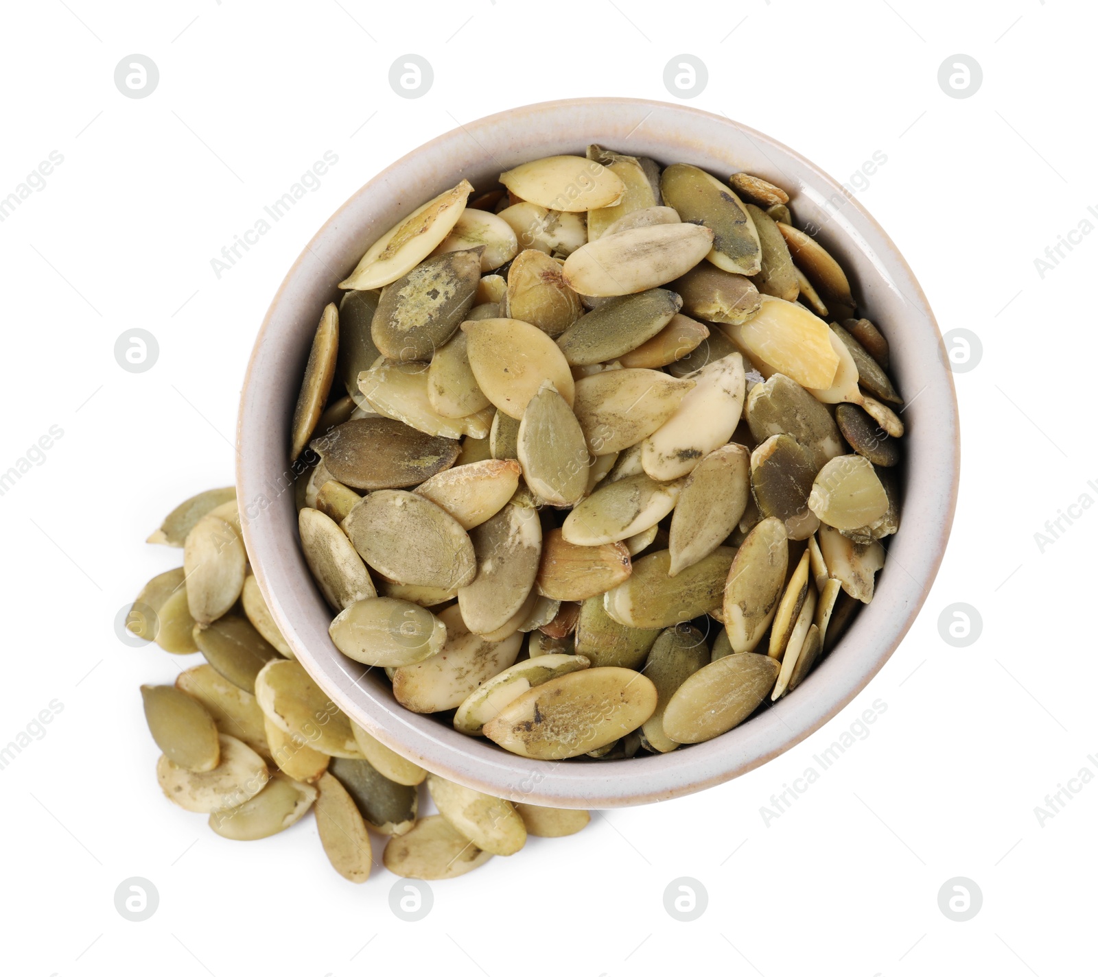 Photo of Peeled pumpkin seeds in bowl isolated on white, top view