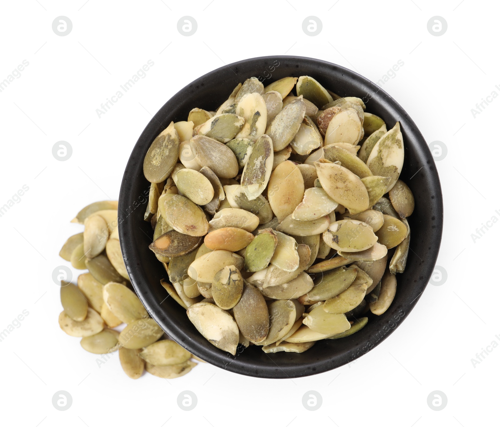 Photo of Peeled pumpkin seeds in bowl isolated on white, top view