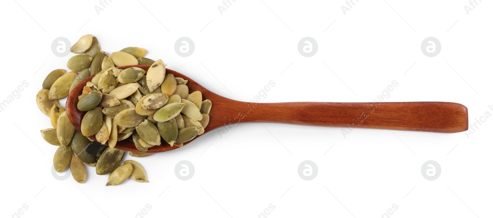 Photo of Peeled pumpkin seeds in wooden spoon isolated on white, top view