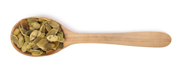 Photo of Peeled pumpkin seeds in wooden spoon isolated on white, top view