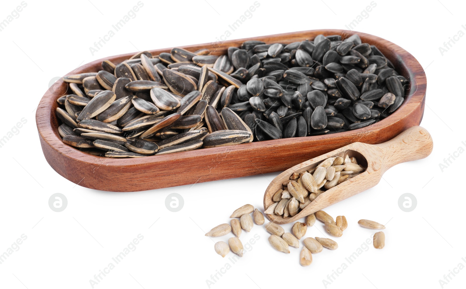 Photo of Different sunflower seeds, wooden plate and scoop isolated on white