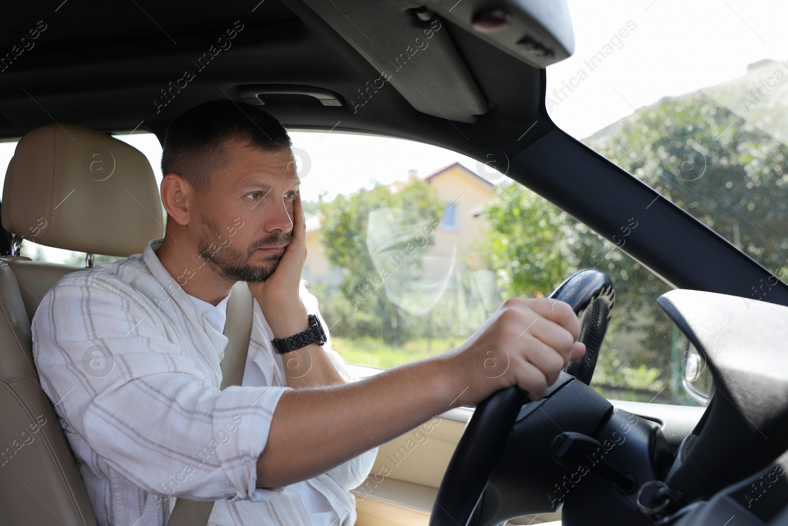 Photo of Man holding steering wheel while driving car