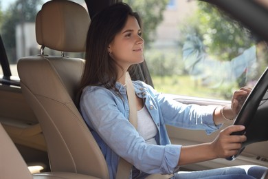 Photo of Woman holding steering wheel while driving car