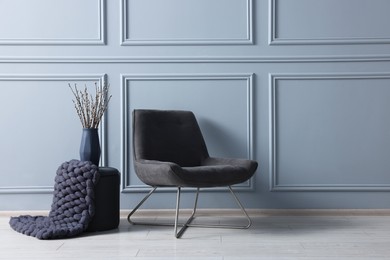 Photo of Stylish stool, chair and vase near light grey wall indoors, space for text